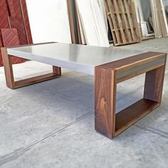 a wooden table sitting on top of a cement floor