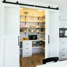 an open pantry with sliding doors in a kitchen