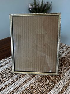 a mirror sitting on top of a table next to a plant