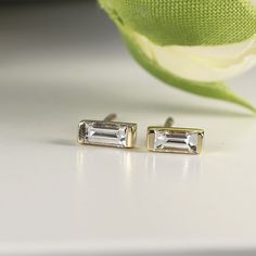 14k Gold baguette diamond stud earrings. DETAILS ABOUT THE EARRINGS ***14k solid gold settings ***Baguette Diamond size 4x2mm 0.07ct each ***Total carat weight 0.14 ctw *** Diamonds are HG color , VS clarity scale. Diamond is a stone that truly states, “I love you” in a deep way, it is symbol of deep, everlasting love. A diamond is forever. Diamond is birthstone for April. You can purchase single or pair, please choose from drop down menu. ----------------------------------- FOLLOW ME HERE: Inst Baguette Cut Diamond Anniversary Earrings, Baguette Cut Diamond Earrings For Anniversary, Fine Jewelry Baguette Cut Diamond Earrings, Modern Baguette Cut White Diamond Earrings, Modern White Baguette Cut Diamond Earrings, Modern Baguette Cut Wedding Earrings, Anniversary Baguette Earrings Fine Jewelry, Modern Baguette Cut Earrings For Wedding, Modern White Baguette Cut Earrings