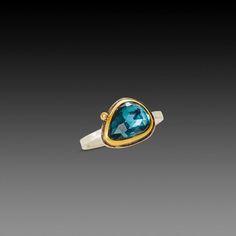 A glowing rose cut London blue topaz is wrapped in warm 22k gold, and accented with 2 sparkling diamonds. This stone has a lovely color, a luminous and sparkly deep blue. Sterling silver back, and 2mm wide hammered band. Stone measures approximately 3/8 inch tall. Matte finish. Glowing Rose, London Blue Topaz Ring, Hammered Band, London Blue Topaz, Blue Topaz Ring, London Blue, Topaz Ring, Sparkle Diamonds, 22k Gold