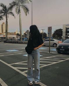 a woman standing in the middle of an empty street