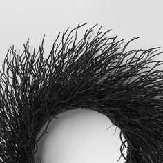 a black twig wreath on a white background