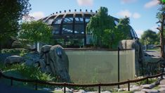 an elephant exhibit in front of a glass dome with trees and rocks surrounding the enclosure