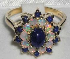 *This ring is made from 750 18K Yellow Gold with Natural Lapis Lazuli & Fiery Opal gemstones.PLEASE ALSO MAKE SURE YOU STATE YOUR TELEPHONE NUMBER WITH YOUR PAYMENT AS THIS MAY BE REQUIRED BY THE SHIPPING CARRIER.This is a WOW! factor ring, showcasing a large 7x5mm (0.28"x0.20" inches) centre vibrant Lapis Lazuli complimented by ten 2.75mm (0.11" inches) fiery Opals and ten 2.25mm (0.09" inches) Lapis Lazuli. A real beauty that is guaranteed to impress.This ring is handcrafted from Solid English Blue Hallmarked Opal Ring For Wedding, Victorian Multi-stone Opal Ring As Gift, Victorian Multi-stone Opal Ring For Gift, Victorian Multi-stone Opal Ring, Antique Blue Multi-stone Jewelry, Blue Multi-stone Antique Rings, Antique Multi-stone Blue Rings, Antique Blue Multi-stone Rings, Cluster Ring Set