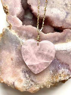 Pretty in pink. This large rose quartz crystal pendant necklace is the perfect healing piece to add to your jewelry collection. Exuding dusty soft shades of pink, rose quartz helps soothe your heart and emit love to those all around you. Embrace the delightful beauty and tranquil benefits of this gentle and graceful creation. Pink Rose Quartz Crystal Pendant Necklace• Beautifully polished raw rose quartz• Soft and feminine style• Loving calm energy — speaks directly to your heart chakra• 14K Gol Spiritual Heart-shaped Rose Gold Necklace, Spiritual Rose Gold Heart Necklace, Rose Gold Heart-shaped Rose Quartz Jewelry, Pink Rose Quartz Crystal Necklace With Natural Stones, Rose Quartz Pendant Necklaces For Healing, Pink Rose Quartz Gemstone Necklaces, Rose Quartz Pendant Necklace With Gemstones, Pink Quartz Jewelry Gift, Pink Quartz Jewelry As A Gift