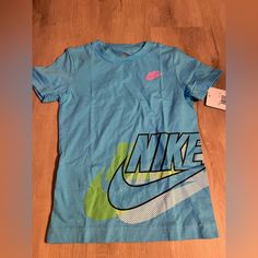 Brand New Nike Tee Sports Shirt With Blue Logo Print, Nike Blue Shirt With Graphic Print, Blue Graphic Tee For Sports, Nike Blue Graphic Tee, Nike Blue Top With Logo Print, Nike Blue Tops With Logo Print, Nike Blue Shirt For Summer, Nike Blue T-shirt For Spring, Blue Logo Print Shirt For Spring