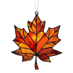 a stained glass maple leaf ornament hanging from a chain