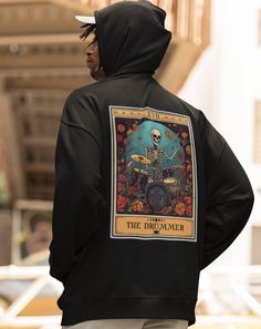 The Drummer Tarot Card Hoodie, Unisex Hooded Sweatshirt for Drum Player Gift, Drummer Hoodie Made with a thick blend of cotton and polyester, it feels plush, soft and warm, a perfect choice for any cold day. In the front, the spacious kangaroo pocket adds daily practicality while the hood's drawstring is the same color as the base sweater. .: Made with a medium-heavy fabric (8.0 oz/yd² (271 g/m that consists of 50% cotton and 50% polyester for that cozy feel and warmth you need in a hoodie. .: Classic fit along with the pouch pocket Band Merch Hoodie For Winter, Winter Band Merch Hoodie, Winter Fan Merchandise Sweatshirt With Adjustable Hood, Band Merch Hooded Sweatshirt With Adjustable Hood, Winter Fan Merchandise Hoodie With Adjustable Hood, Fleece Hooded Sweatshirt For Fan Merchandise, Fleece Hooded Sweatshirt For Fans, Winter Fan Apparel Hooded Hoodie, Fleece Hooded Hoodie Fan Merchandise