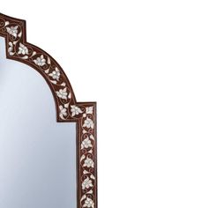 a mirror with an intricate design on the top and bottom edge, is shown against a white background