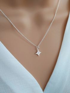 North star necklace sterling silver, Polaris starburst necklace, celestial star jewelry, silver cz diamond star necklace Shine bright with our gorgeous North Star necklace!  Handcrafted with care using a tiny sterling silver & cubic zirconia North Star charm and delicate sterling silver chain, this dainty necklace symbolises hope and inspiration.  The North Star is the anchor of the northern sky, giving guidance and direction to those who follow it. Stunning little cubic zirconia crystals mimic Diamond Star Necklace, Granddaughter Necklace, North Star Necklace, Starburst Necklace, The North Star, Diamond Star, Star Jewelry, Cz Diamond, North Star