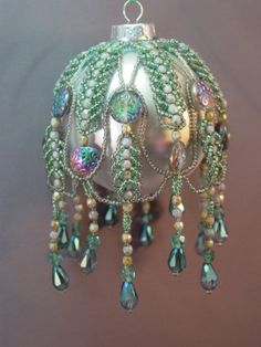 an ornament with beads and pearls hanging from it