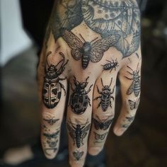 a person's hand with tattoos on it and many bugs around the fingers,