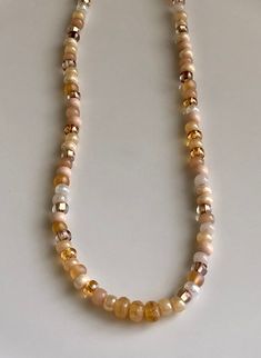 "beaded choker short beaded necklace pink and gold necklace This choker-length necklace was made using Czech glass seed beads in shiny and matte shades of pink and peach and white and gold. They were strung on strong beige nylon cord. The lobster clasp and all closure components are gold plated brass. Length of necklace, from end to end, is 15 1/2\" plus 2\" extender chain. Glass beads measure 4mm, 1/6\" You can enter my shop here: gypsydangles.etsy.com" Beige Beaded Necklace With Gold Round Beads, Beige Necklace With Colorful Round Beads, Gift Beige Beaded Necklace With Colorful Beads, Apricot Beaded Round Bead Jewelry, Adjustable Cream Necklace With Colorful Beads, Peach Beaded Necklaces With Round Beads, Adjustable Beige Necklace With Colorful Beads, Adjustable Beige Necklaces With Colorful Beads, Boho Leather Necklace