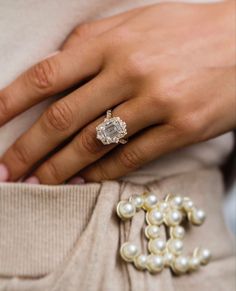 a close up of a person's hand wearing a ring