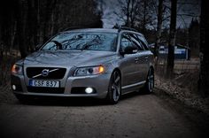 a volvo car parked in the woods at night