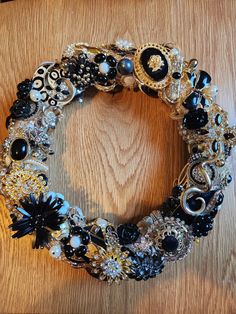 a close up of a wreath on a table with brooches and other items