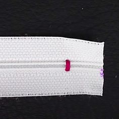 a piece of white fabric with red stitching