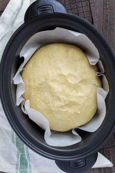 an uncooked round bread in a crock pot