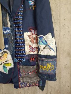 a blue jacket with birds and butterflies on it