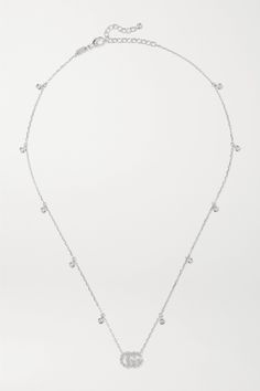 Gucci's delicate necklace is an easy and subtle way to incorporate the house's iconic 'GG' motif into everyday outfits. Cast from 18-karat white gold, it's set with 0.22-carats of shimmering diamonds and has an adjustable chain. Show yours of with plunging necklines. Gucci White Gold Jewelry With Diamond Accents, Gucci Jewelry With Diamond Accents For Gift, Gucci Fine Jewelry With Diamond Accents, Gucci Diamond Jewelry With Diamond Accents, Gucci Sterling Silver Classic Jewelry, Gucci Sterling Silver Jewelry, Classic Gucci Sterling Silver Jewelry, Modern Gucci Sterling Silver Jewelry, Elegant Gucci Sterling Silver Jewelry