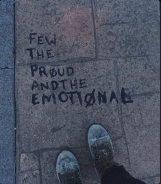 someone is standing on the sidewalk with their feet up in front of them and writing on the pavement