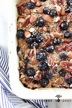 blueberry baked oatmeal with pecans and almonds in a white dish