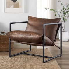 a brown leather chair sitting on top of a wooden floor