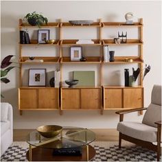 a living room filled with lots of furniture and bookshelves on top of shelves