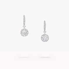 From the Classic Graff collection, our Icon earrings are quintessential Graff. Showcasing two round brilliant diamonds, the centre stones are orbited by halos of pavé diamonds, augmenting their brilliance. Suspended from a precise line of pavé diamonds, set upon delicately crafted white gold French wire, the slender setting and halo effect of the diamond drops serve to amplify their brilliance: the ultimate display of virtuosity, captured in a timelessly elegant design. Model wears an elegant pa Graff Jewelry, Diamond Shaped Engagement Ring, Icon Jewelry, Graff Diamonds, Round Diamond Pendant, Round Diamond Earrings, Halo Effect, Diamond Earrings Studs Round, Fine Diamond Jewelry