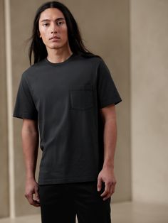 A classic crew in ultra comfortable fabric, this SUPIMA® cotton t-shirt is soft and strong, crafted from cotton that is American grown.  Water Savings: This garment-dyed style uses 4 fewer gallons of water (compared to traditional garment dye processes).  Crew neck.  Chest pocket.  Flatlock seams for a smooth fit.  Straight hem with vented sides.  Standard fit.  Short sleeves.  Hits at the hip.  Body length (size M): Regular 28", Tall 29. 5" Sleeve length: Regular 18", Tall 18. 75" Model: Size M Cute Food Drawings, Supima Cotton, Men Boys, The Gap, Wearing Black, Black Tshirt, Mens Hairstyles, Cotton T Shirt, Beautiful People