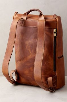 a brown leather bag sitting on top of a table