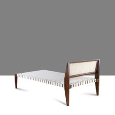 the bed frame is made out of wood and has a white upholstered mattress