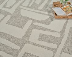 a table topped with an open book on top of a rug