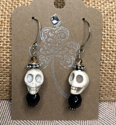 "Make all of your \"Ghoul-friends\" jealous with these adorable Skull Dangle Earrings. This is Spooky Vintage Glamour at its best!                                  The perfect October Hostess Gift  These bone- colored howlight skull beads are accentuated with black faceted crystals and 4mm Czech glass crystals.   1 1/4\"L x 1/2\" W These dangle skull earrings will complete your Halloween wardrobe! You want to see these earrings in multi- colors?! Check out the Colored Skull Earrings here: https: Halloween Skull Jewelry In Bone Color, Halloween Skull Shaped Bone Jewelry, Handmade Bone Jewelry For Halloween, Novelty Black Skull Earrings, Halloween Skull Jewelry With Ear Wire, Halloween Novelty Drop Earrings Jewelry, Spooky Skull Jewelry For Gifts, Halloween Novelty Drop Earrings, Novelty Drop Earrings For Halloween