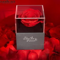 a red rose is in a clear box with the words i love you forever on it