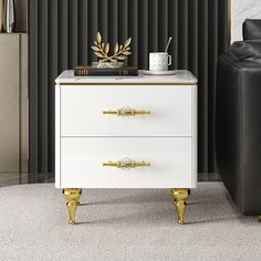 a white and gold chest of drawers in a living room