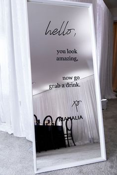 there is a sign that says hello, you look amazing now go grab a drink