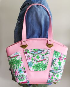 "Another great shoulder bag made from custom canvas and pink vinyl. On the front of the bag is a slip pocket with flap that has a magnetic closure. Along the top there is a zipper closure to keep everything safe.  Not to mention a very roomy inside for all your needs with slip pockets and a zipper pocket too. Approx 10.75\" x 17\" x 4.5\"" Retro Pink Shoulder Bag With Adjustable Strap, Pink Retro Shoulder Bag With Adjustable Strap, Retro Pink Shoulder Bag For Daily Use, Retro Pink Satchel Shoulder Bag, Pink Retro Satchel Shoulder Bag, Retro Pink Shoulder Bag For Everyday Use, Pink Coated Canvas Crossbody Bag, Vintage Pink Shoulder Bag For Everyday, Vintage Pink Satchel For Everyday Use