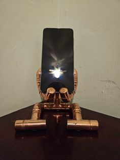 a cell phone sitting on top of a wooden table