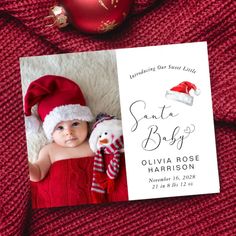 a christmas card with a baby wearing a santa hat