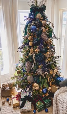 a christmas tree decorated with blue and gold ornaments