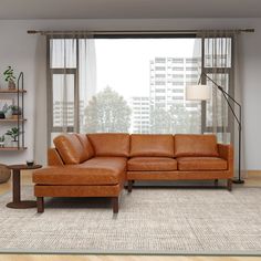 a living room with a couch, chair and table in front of a large window