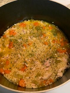 a pot filled with rice and vegetables on top of a stove