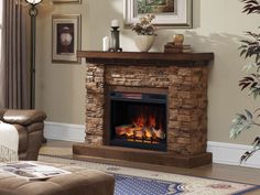 a living room with a fire place in the center and pictures on the wall above it