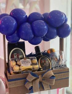 a basket filled with blue balloons and wine