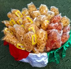 several bags of pasta sitting on the ground