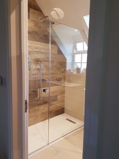 a walk in shower sitting inside of a bathroom