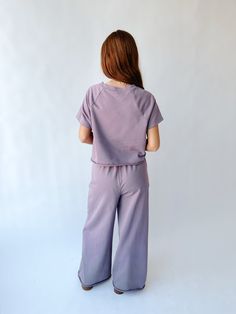 Unleash your playful side with The Reidel Tee and Wide Leg Pant Set in Mauve. Perfect for any occasion, this set combines comfort and style with a quirky twist. You'll definitely stand out in this unique and fun set! Details self/lining: 80%cottron + 20% polyester Fabric Care Guide Here Sizing & Fit Measurements are approximate and taken while laying flat across the front. Not doubled. top small: bust = 21"; length = 20" medium: bust = 22"; length = 20.5" large: bust = 23"; length = 21" bottom s Playful Cotton Bottoms With Relaxed Fit, Playful Cotton Sweatpants For Loungewear, Casual Spring Loungewear Pant Set, Casual Cotton Pant Set, Casual Matching Set With Wide Leg, Casual Wide Leg Matching Set, Playful Cotton Bottoms In Matching Set, Short Sleeve Tops With Elastic Waistband For Lounging, Casual Relaxed Fit Cotton Pant Set