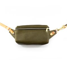 Olive An updated version of your favorite belt bag, now with a zipper closure and a strap clasp. Wear it cross body, across your hips or throw it over your shoulder. Tuck it under your arm when you're on the go, wear it under your coat, dance the night away hands free. It's our crowd favorite with good reason. Features:• Full grain leather bag, adjustable strap, and solid brass hardware. Measures:• 9in wide, 5in tall, 3in deep • Adjustable total length from 38in - 51in (if you need a shorter or